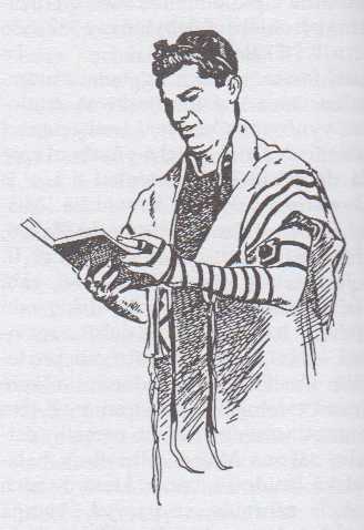Modlící se Žid s modlitebními řemínky (tfilin), tradiční pokrývkou hlavy (kipa) a modlitebním pláštěm (talit)